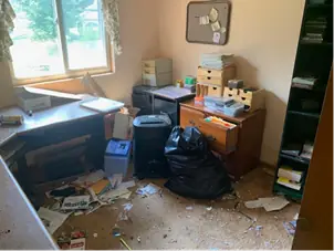 Home office before the clear-out, bins and black bags by the desk