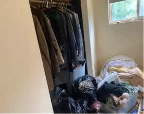 Closet packed with coats and bags on the floor