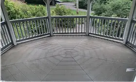 Gazebo deck swept and empty, garden visible beyond the rails