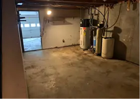 Basement floor cleared around the water heaters and oil tank